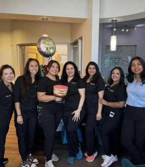 dr. vijaya kallam with her dental team in frisco